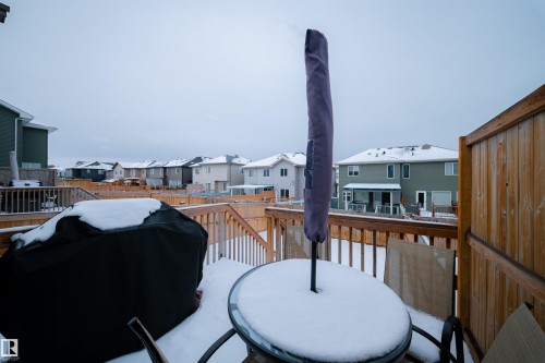 The property features a wooden deck with a privacy screen and railings, overlooking the backyard - 2132 52 St, Edmonton, AB - Outdoor With Exterior