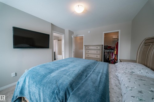 This room features light-colored walls and carpeted flooring - 2132 52 St, Edmonton, AB - Indoor Photo Showing Bedroom