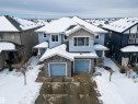 This property features a light blue exterior with stone facade accents and a double garage - 2132 52 St, Edmonton, AB  - Outdoor With Facade 