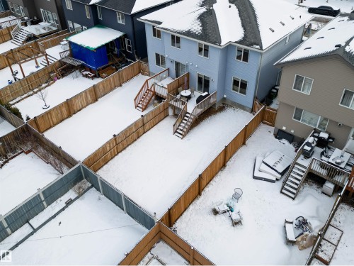 The property features a fenced yard, a wooden deck, and a sliding glass door providing access to the yard - 2132 52 St, Edmonton, AB - Outdoor With Exterior