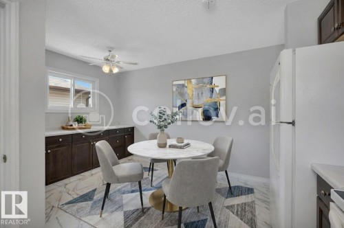 Dining area featuring marble-finish flooring, dark wood cabinetry with white countertops, and a ceiling fan - 12140 53 Street, Edmonton, AB - Indoor Photo Showing Dining Room