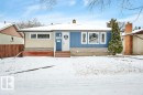 The property features a blue and beige exterior with white trim windows and a white front door - 12140 53 Street, Edmonton, AB  - Outdoor 