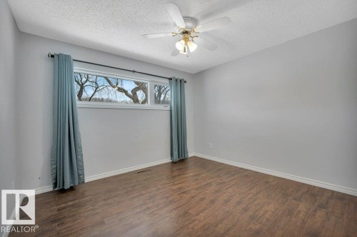 Room featuring wood-look flooring, light-colored walls, and a ceiling fan - 12140 53 Street, Edmonton, AB - Indoor Photo Showing Other Room
