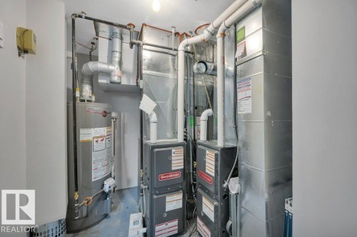 The property includes a water heater and two furnaces, along with extensive ductwork - 12140 53 Street, Edmonton, AB - Indoor Photo Showing Basement