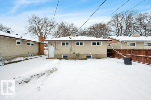 The property features a stucco exterior with a durable roofing system and multiple windows providing natural light - 12140 53 Street, Edmonton, AB - Outdoor