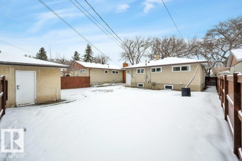 The property includes a detached garage with a white door and a fenced yard - 12140 53 Street, Edmonton, AB - Outdoor With Exterior