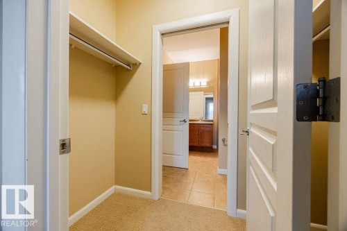 The walkthrough closet provides direct access the the 4-pce bath. - 217 160 Magrath Road, Edmonton, AB - Indoor Photo Showing Other Room