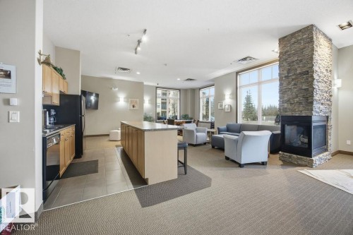 217 160 Magrath Road, Edmonton, AB - Indoor With Fireplace