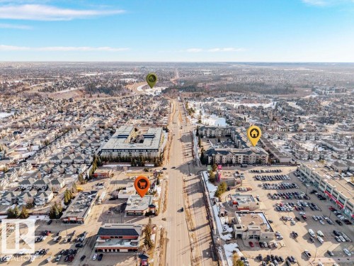 Aerial view of the community, showcasing residential properties and commercial establishments - 217 160 Magrath Road, Edmonton, AB - Outdoor With View