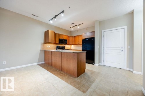 The entrance features ceramic tile flooring. - 217 160 Magrath Road, Edmonton, AB - Indoor Photo Showing Kitchen