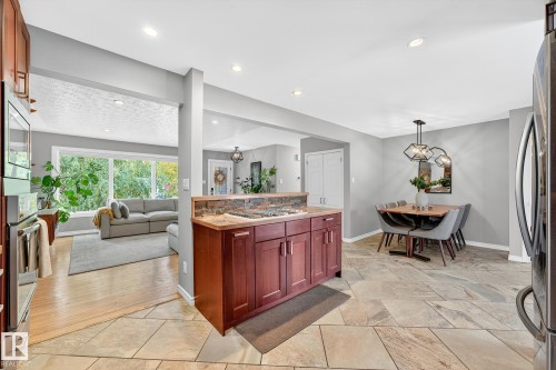 The property features an open-concept layout with light gray walls and recessed lighting - 15701 92A Avenue, Edmonton, AB - Indoor