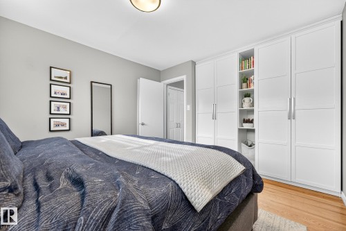 This room features light gray walls, a light fixture on the ceiling, and hardwood flooring - 15701 92A Avenue, Edmonton, AB - Indoor Photo Showing Bedroom