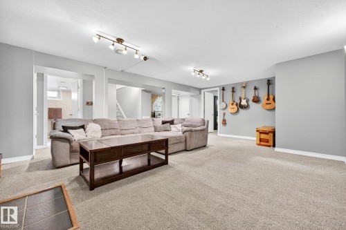 Spacious room featuring light grey walls, light-colored carpet, and recessed lighting fixtures - 15701 92A Avenue, Edmonton, AB - Indoor Photo Showing Living Room
