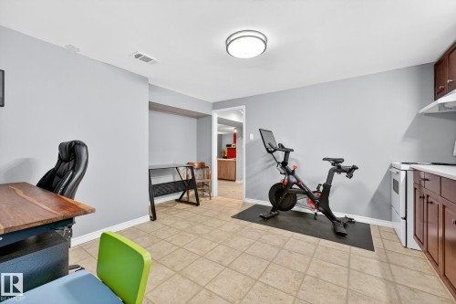 The property features light gray walls and tiled flooring throughout the space - 15701 92A Avenue, Edmonton, AB - Indoor Photo Showing Gym Room