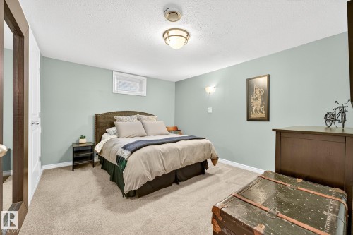 This room features light green walls, a neutral carpet, and a window with blinds - 15701 92A Avenue, Edmonton, AB - Indoor Photo Showing Bedroom