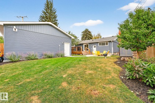 The property features a spacious yard with a lawn area, mature landscaping, and a fenced perimeter - 15701 92A Avenue, Edmonton, AB - Outdoor