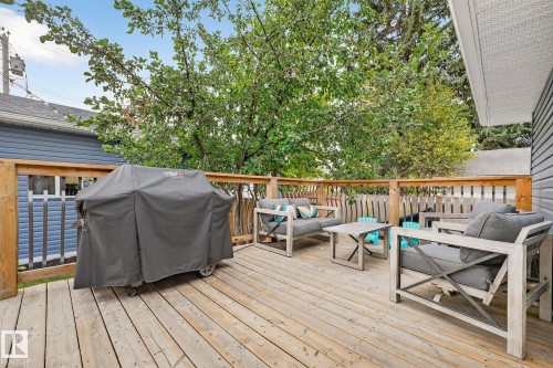 The property features an outdoor wood deck with a wooden railing, providing an inviting space for relaxation - 15701 92A Avenue, Edmonton, AB - Outdoor With Deck Patio Veranda With Exterior