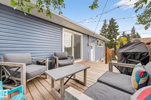 The property features a wooden deck with outdoor lighting, accessible via a sliding glass door - 15701 92A Avenue, Edmonton, AB - Outdoor With Deck Patio Veranda With Exterior