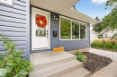 The property features a white front door with an ornate glass insert, complemented by contemporary house numbers - 15701 92A Avenue, Edmonton, AB  - Outdoor 