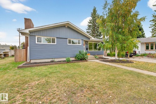 This property features a well-maintained lawn and a paved driveway - 15701 92A Avenue, Edmonton, AB - Outdoor