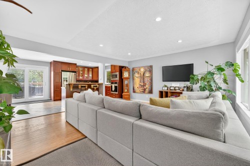 Living area with light wood flooring, recessed lighting, and large windows providing natural light - 15701 92A Avenue, Edmonton, AB - Indoor Photo Showing Living Room