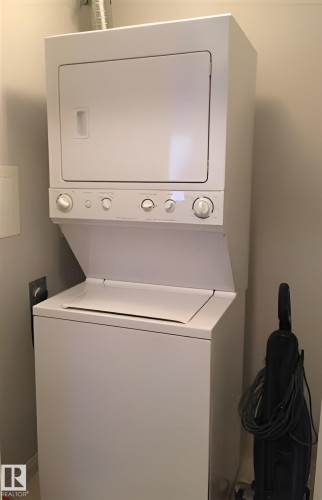 The property includes a white stacked washer and dryer unit - 136 16221 95 Street, Edmonton, AB - Indoor Photo Showing Laundry Room
