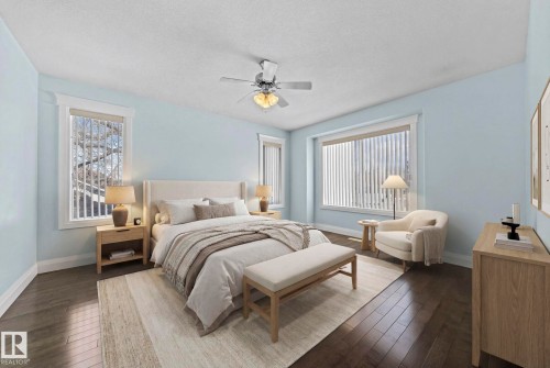 Bedroom featuring dark wood floors, light blue walls, and a ceiling fan - 12913 124 Street, Edmonton, AB - Indoor Photo Showing Bedroom