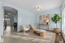 Living area featuring light blue walls, hardwood flooring, and an arched entryway - 12913 124 Street, Edmonton, AB  - Indoor 