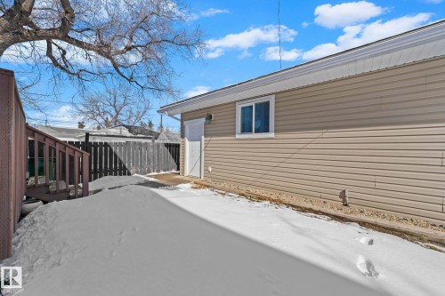 The property features tan horizontal siding and a window - 12913 124 Street, Edmonton, AB - Outdoor