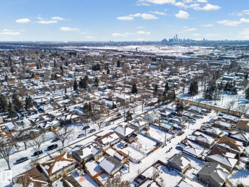 Aerial view of the neighborhood showcasing residential properties with snow-covered rooftops and yards - 12913 124 Street, Edmonton, AB - Outdoor With View
