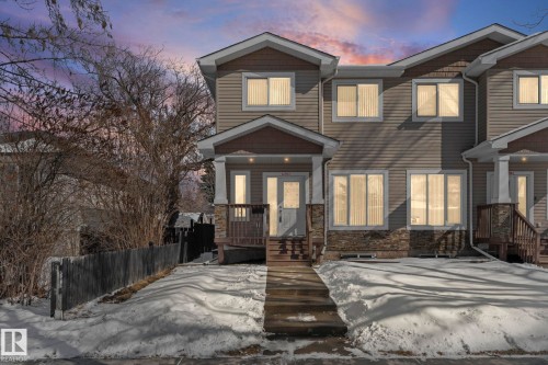This property features a two-story exterior with horizontal siding and stone accents - 12913 124 Street, Edmonton, AB - Outdoor