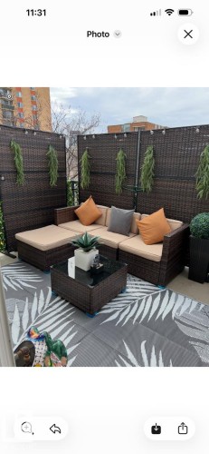 Outdoor patio featuring a privacy screen, a sectional seating area, and a patterned area rug - 443 10403 122 Street, Edmonton, AB - Outdoor With Deck Patio Veranda