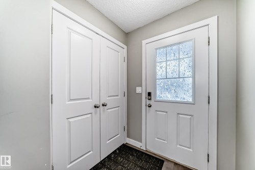 Front entrace foyer.Closet and half bathroom. Flooring Ceramic Tile. - 1723 Hammond Crescent Nw, Edmonton, AB - Indoor Photo Showing Other Room