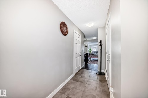 View from the front door entry towards the main floor living area. - 1723 Hammond Crescent Nw, Edmonton, AB - Indoor Photo Showing Other Room