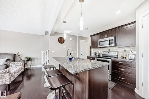 Family friendly, High end  GRANITE counter top. drop down counter for bar stools, Stainless steel appliance, PANRTY IN THE CORNER. - 1723 Hammond Crescent Nw, Edmonton, AB - Indoor Photo Showing Kitchen With Upgraded Kitchen