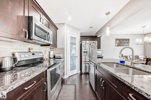 Large pantry for family needs. Glass doos. - 1723 Hammond Crescent Nw, Edmonton, AB - Indoor Photo Showing Kitchen With Double Sink With Upgraded Kitchen