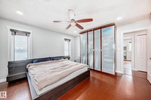 The property features a bedroom with rich brown flooring, a ceiling fan, and recessed lighting - 3107 43 Avenue, Edmonton, AB - Indoor Photo Showing Bedroom