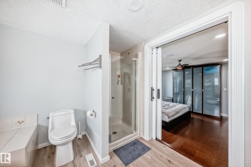 Bathroom featuring a toilet, a shower with a glass enclosure, and light-colored flooring - 3107 43 Avenue, Edmonton, AB - Indoor Photo Showing Bathroom