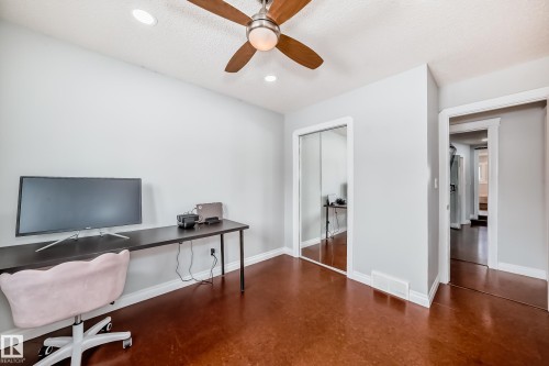 This room features a ceiling fan with integrated lighting, recessed lighting, and mirrored closet doors - 3107 43 Avenue, Edmonton, AB - Indoor Photo Showing Office