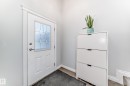 Entryway featuring a white door with decorative glass inserts, light grey walls, and a tiled floor - 3107 43 Avenue, Edmonton, AB  - Indoor Photo Showing Other Room 