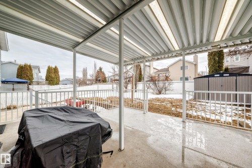 The property features a spacious covered patio with a concrete surface and a white railing, providing an outdoor living area - 3107 43 Avenue, Edmonton, AB -  With Exterior