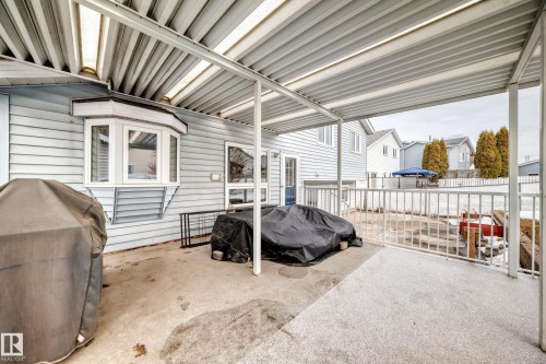 The property features a spacious covered patio area, ideal for outdoor living, with a bay window visible on the exterior wall - 3107 43 Avenue, Edmonton, AB - Outdoor With Exterior