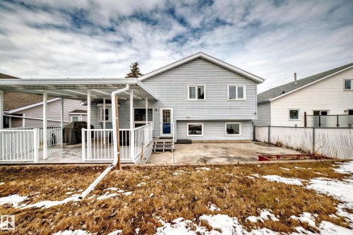 The property features a covered deck with white railings, providing an inviting outdoor space - 3107 43 Avenue, Edmonton, AB - Outdoor With Deck Patio Veranda
