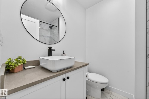 Bathroom featuring vanity, tiled shower, and light marble finish floors - 8604 142 Street, Edmonton, AB - Indoor Photo Showing Bathroom