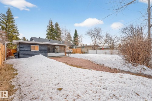 Snow covered property with a fenced backyard and a sunroom - 8604 142 Street, Edmonton, AB - Outdoor