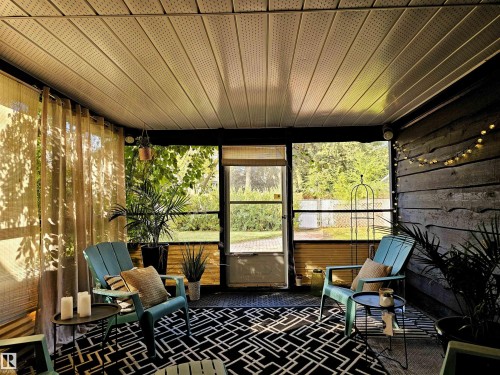 The property features an enclosed patio area with a slatted ceiling and wood plank walls - 8604 142 Street, Edmonton, AB - Outdoor With Deck Patio Veranda With Exterior