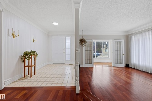 The entryway features a white front door with a sidelight, tiled flooring, and a skylight - 131 Walsh Crescent, Edmonton, AB - Indoor Photo Showing Other Room
