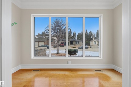 This room features a large window with white framing, providing views of the surrounding neighborhood - 131 Walsh Crescent, Edmonton, AB - Indoor Photo Showing Other Room