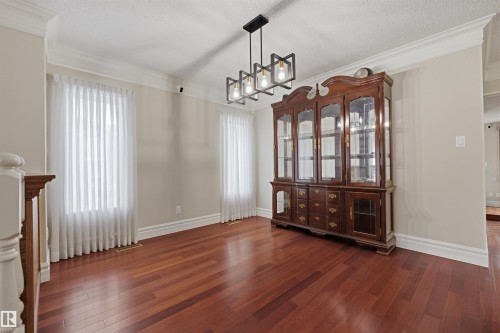 This room features hardwood floors, light-colored walls, and crown molding - 131 Walsh Crescent, Edmonton, AB - Indoor Photo Showing Other Room