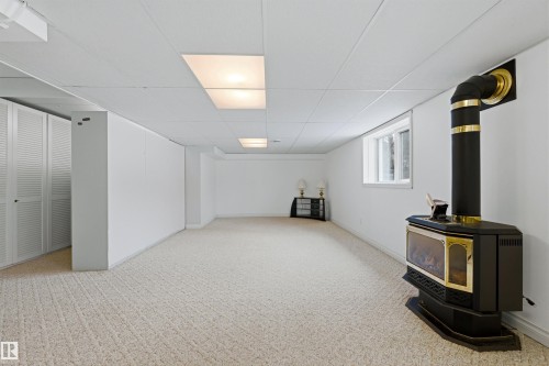 Spacious room featuring carpeting, a white drop ceiling with recessed lighting, and a window providing natural light - 131 Walsh Crescent, Edmonton, AB - Indoor Photo Showing Other Room
